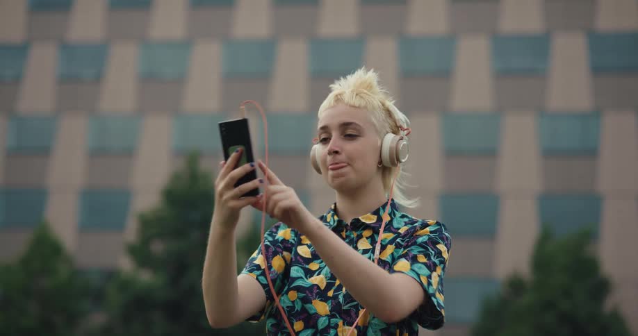 A woman talks on her phone on a windy day