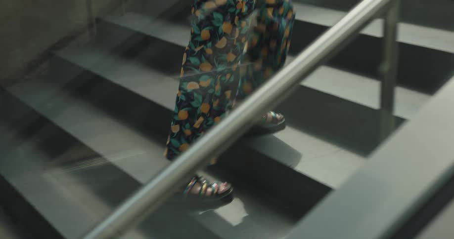 A woman climbs the staircase