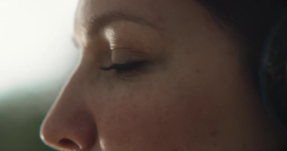 Close up of woman with headphones listening to music