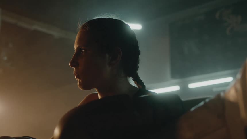 A woman is standing in a room by herself