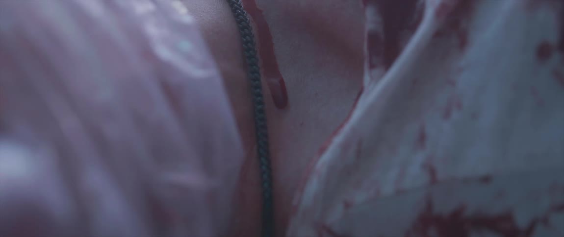 A drop of blood on a womans chest