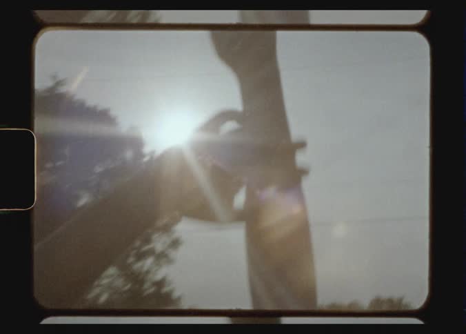 A person waves their hands in the air in this old footage