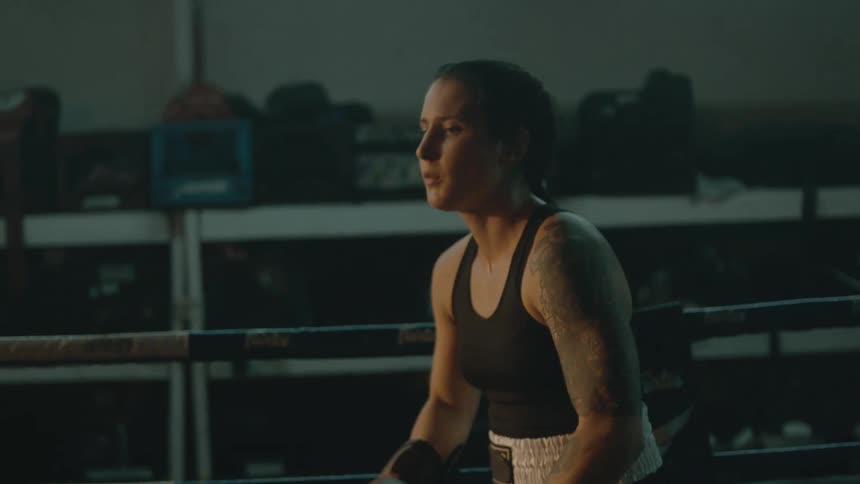A woman jumps around tired from boxing practice
