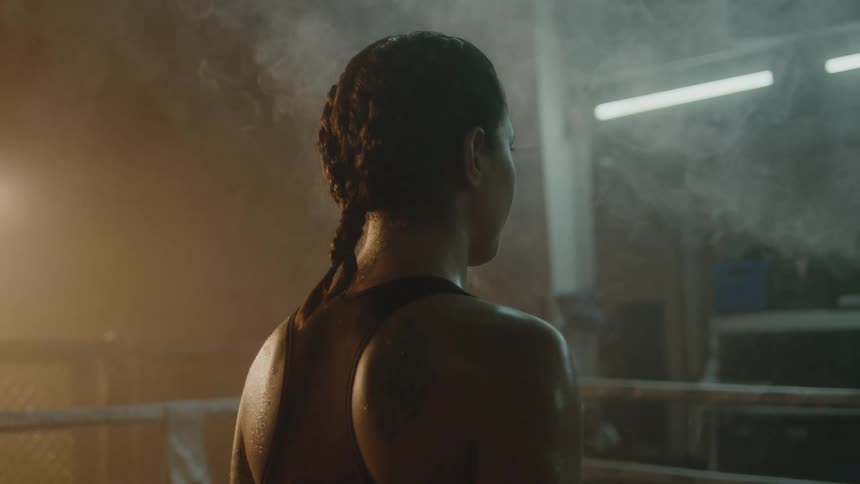 A woman is standing in a room with smoke