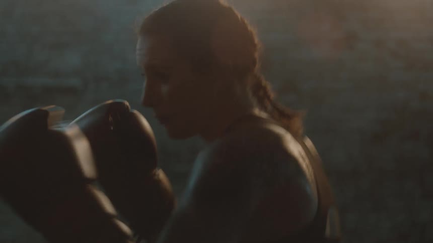 A woman is punching the heavy bag