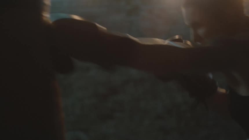 A woman is boxing aggressively in a room