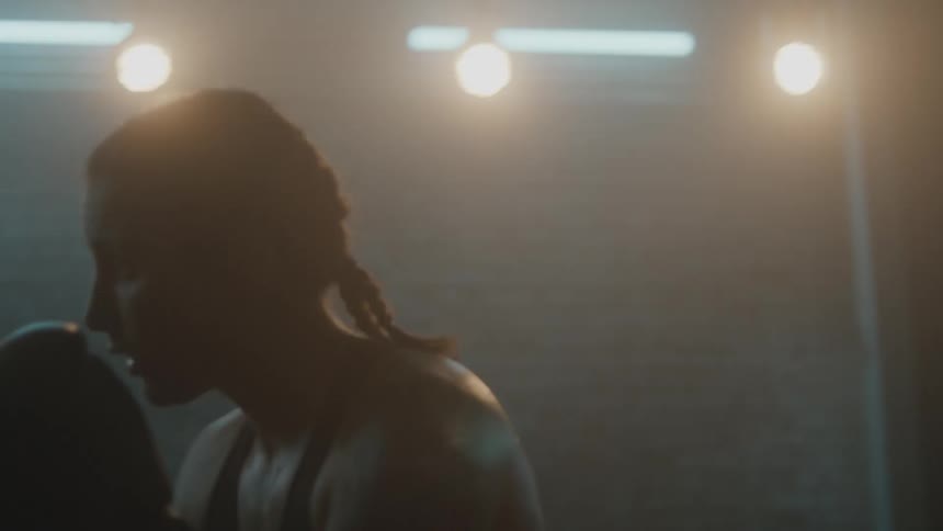 A woman is punching the heavy bag