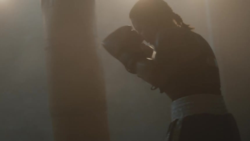 A woman is boxing in an empty building