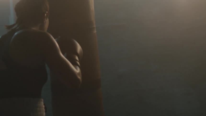 A woman is boxing in a room by herself