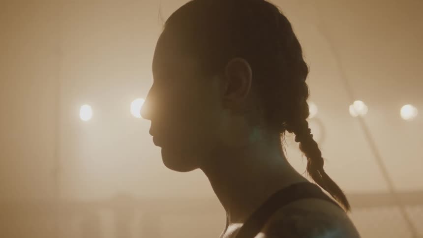 A portrait of a woman who is wearing her hair in a braid