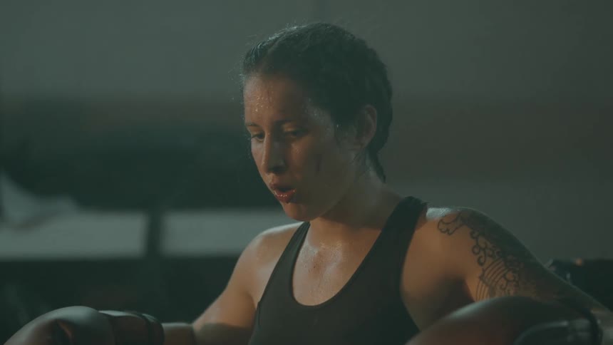 A woman is resting after an intense work out