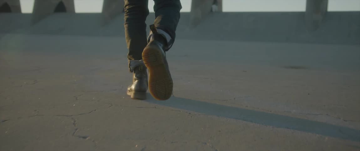 A person is walking on a sunny day