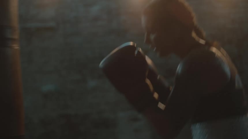 A woman is boxing in a building by herself