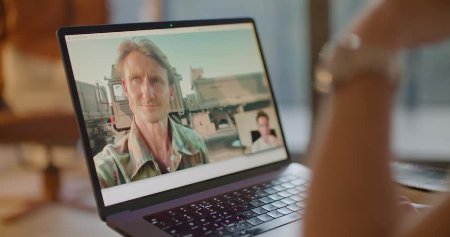 A man is having a video conversation on a laptop computer with another man