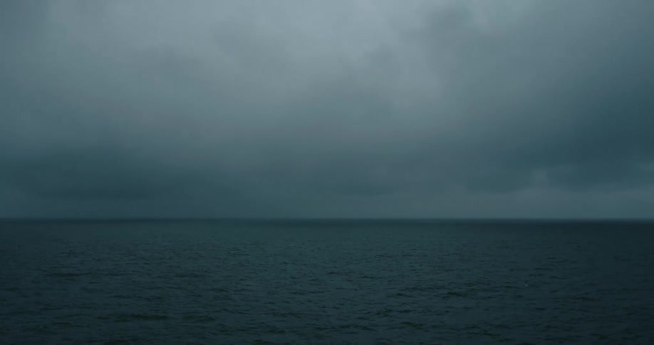 View of ocean horizon under the dark storm clouds