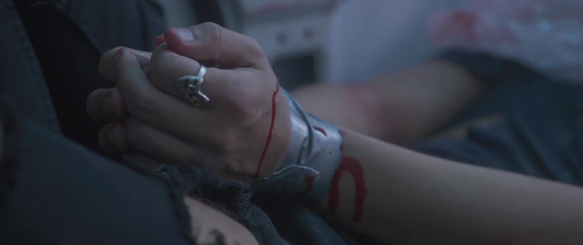A womans bound hands with blood dripping onto the duct tape