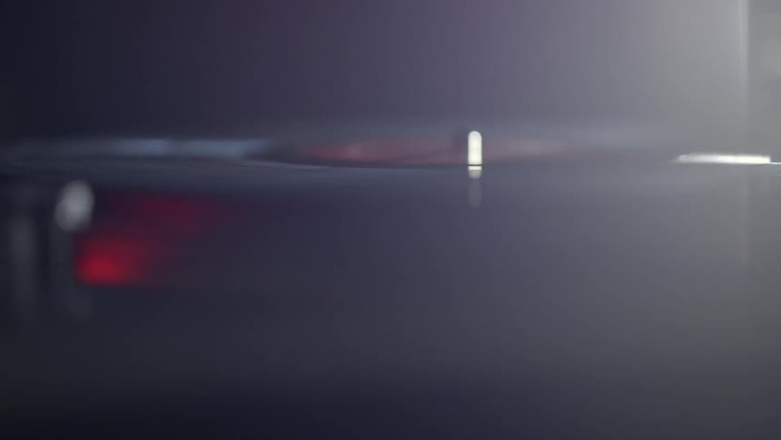 A record spins in a dim room