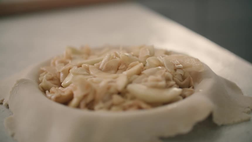 A bowl of cooked noodles is displayed on a counter