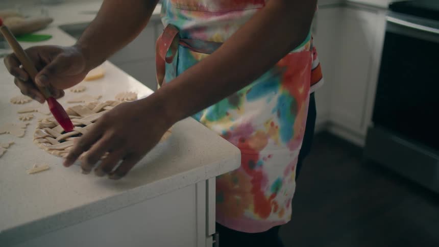 A person is preparing a pie on their kitchen counter