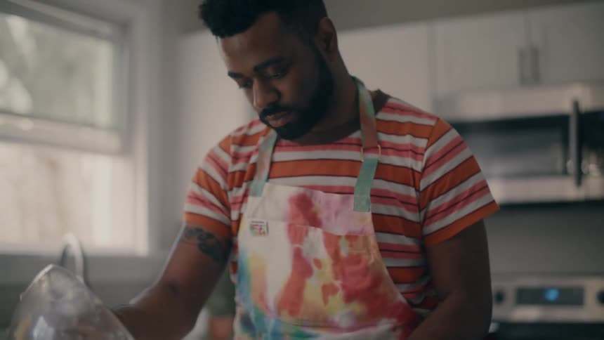 A man is mixing ingredients for a dessert in his kitchen