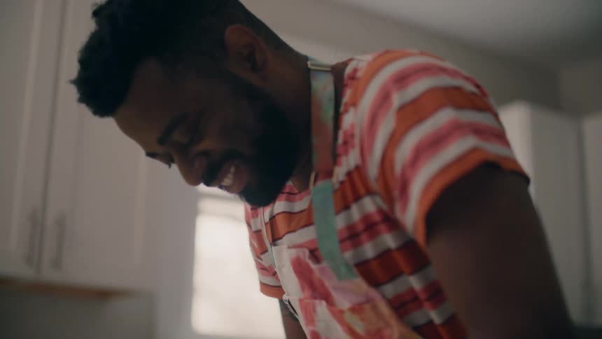 A man is in his kitchen and cooking food
