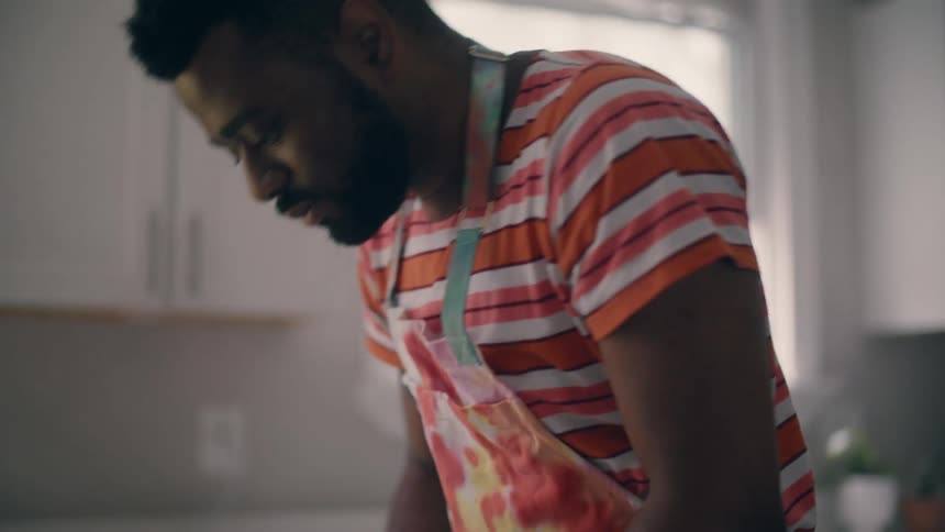 A man is preparing to cook a dessert in his kitchen