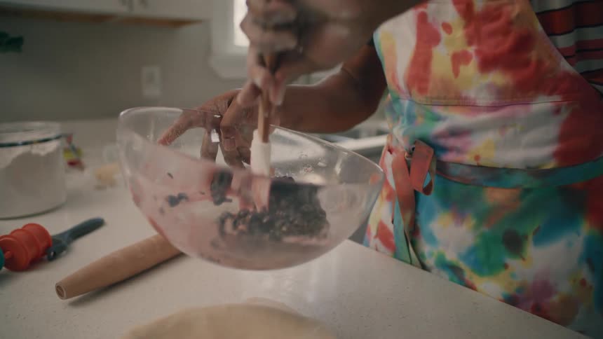 A man is preparing a dessert in his kitchen