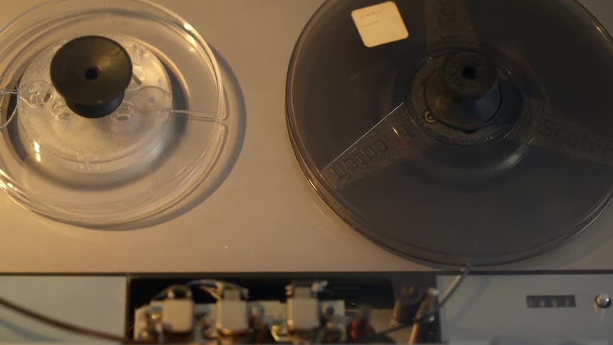 A person puts tape in a player