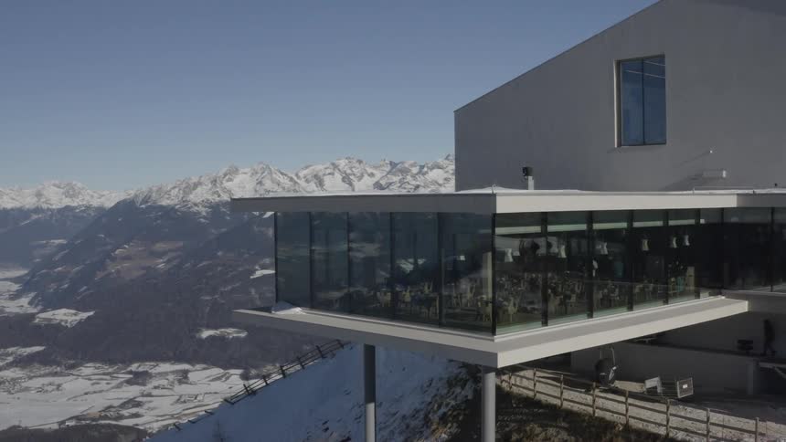 A large building on the top of a mountain on a clear day