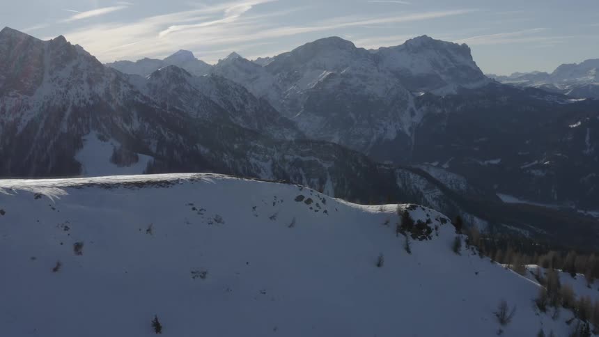 Aerial view of the snow covered slopes of a mountain range at daytime