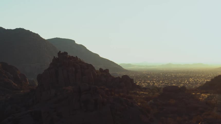 Hazy desert grasslands and ancient mountains