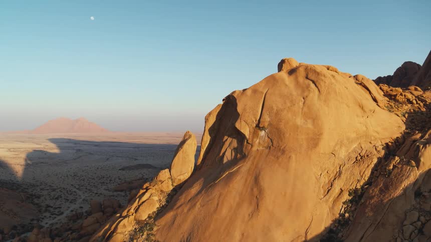 Sun drenched desert mountain aerial