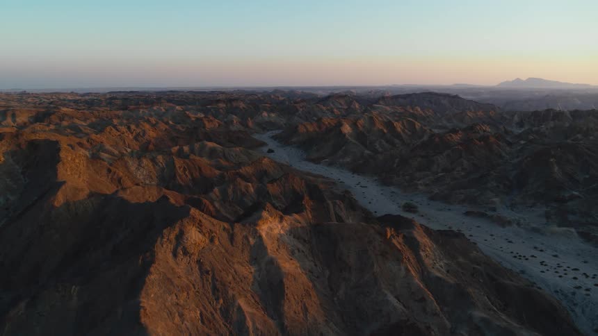 Aerial of jagged mountain peaks at sunset