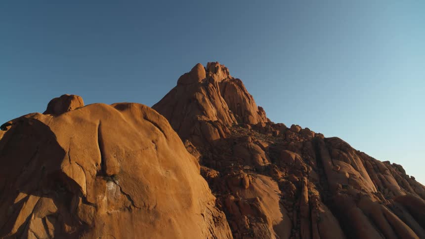 Golden desert mountains against a bright blue sky