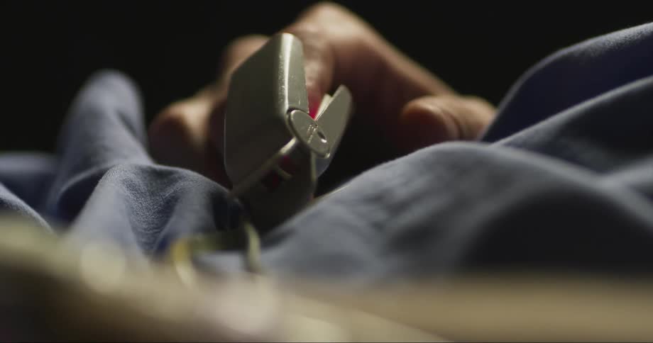 Patient resting on a bed with a pulse oximeter on his finger