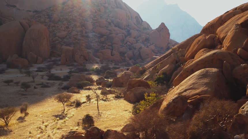 Giant boulders at the base of desert mountains aerial