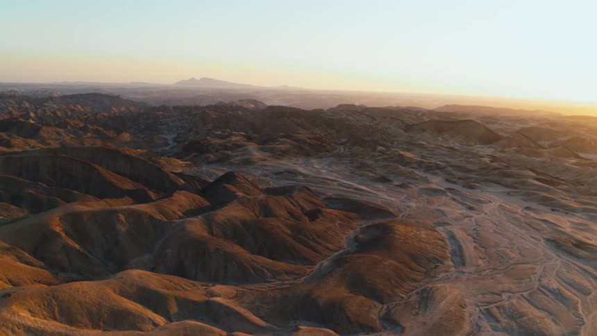 Aerial view of mountainous desert at sunset