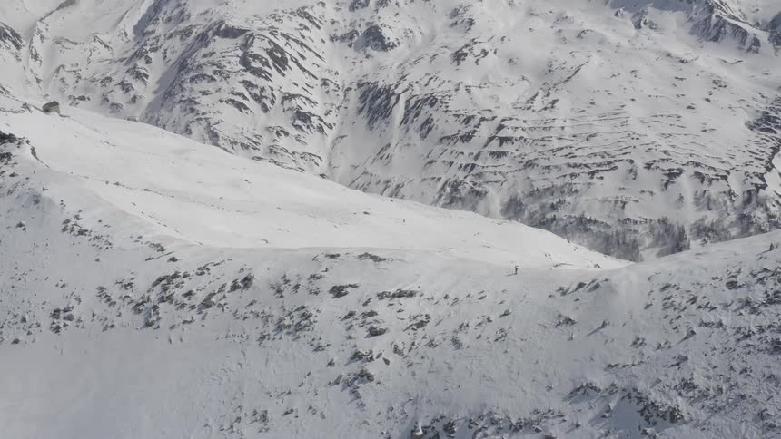 A person is skiing on the snow covered mountains
