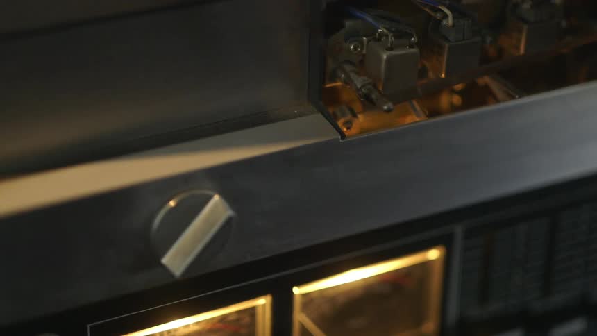 Close up of a person fixing tape in a machine