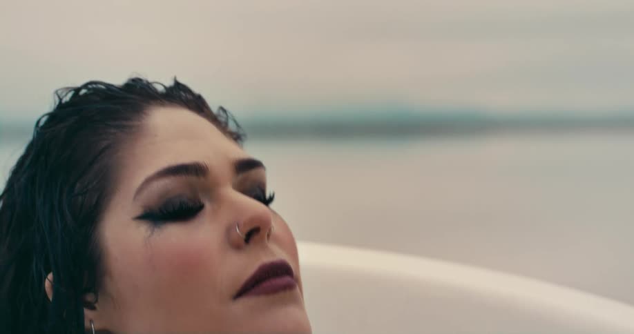 A woman laying in a bath tub