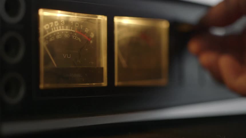 Someone adjusts knobs of a machine
