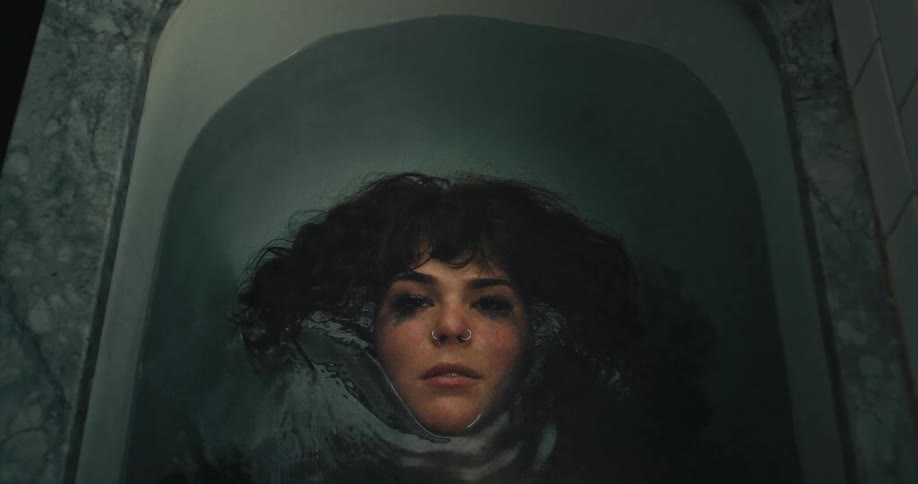 A woman laying in a bath tub