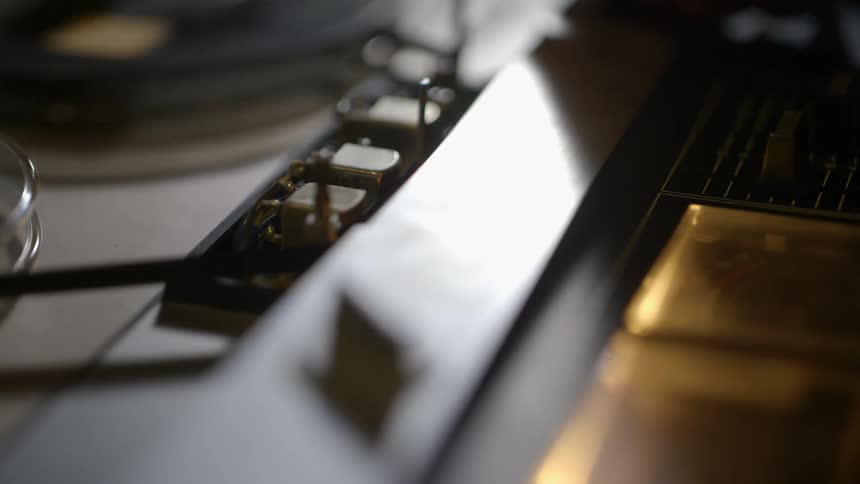 Close up of a tape machine as it is turned on