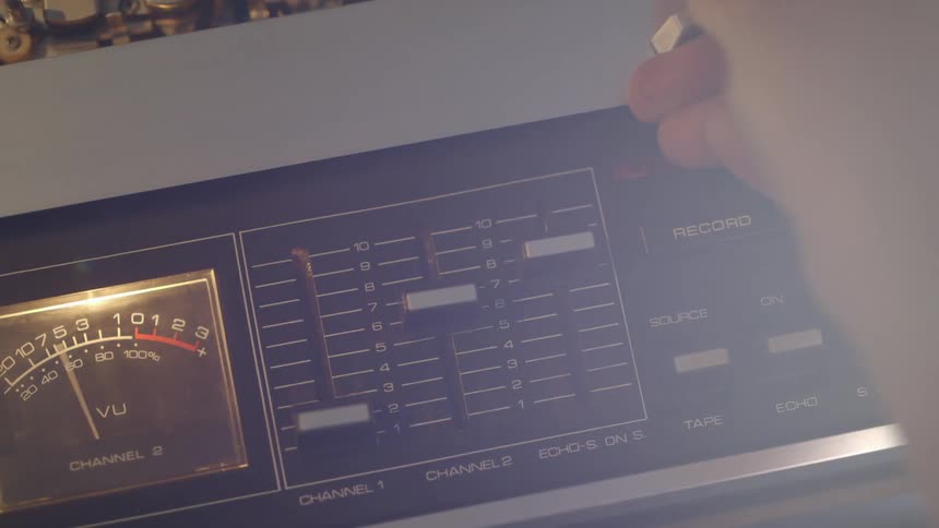 A machine is turned on and someone adjusts some of the knobs
