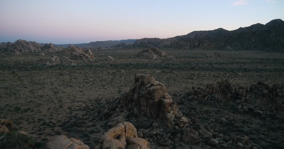 Rocky formations on the plains near the mountains in the badlands at evening