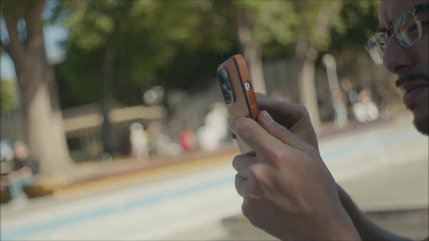Man films area using his smartphone on sunny day