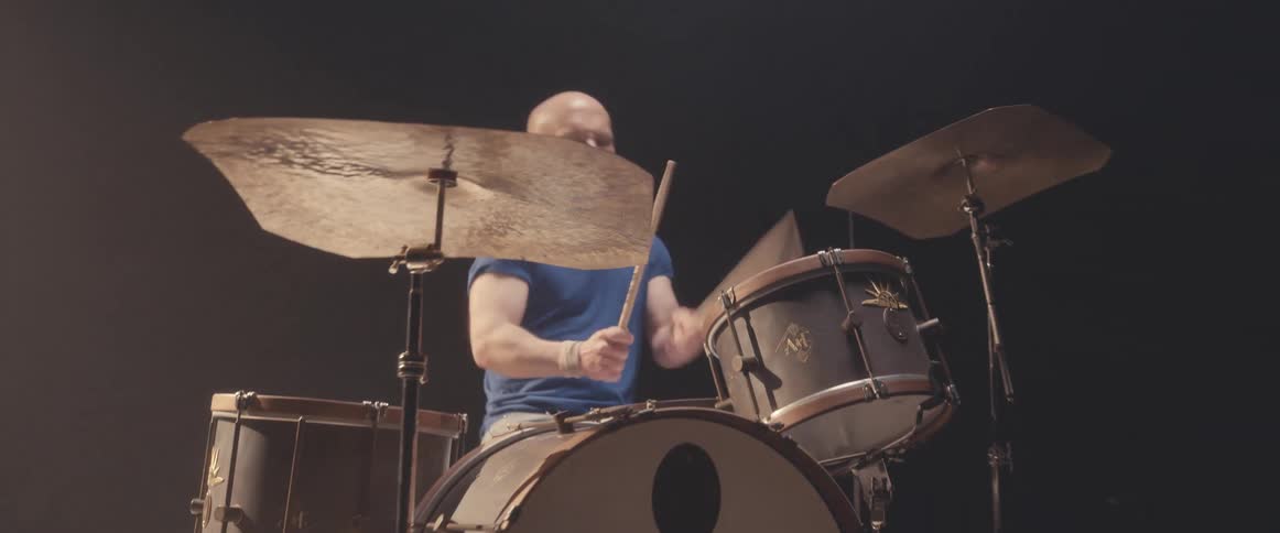 A man plays a song on drums