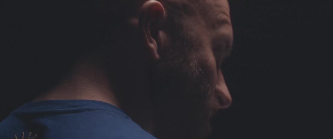 A man moves his head to the beat as he plays the drums