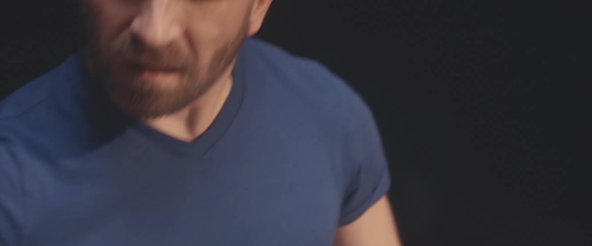 A man seems to practicing drums in a studio