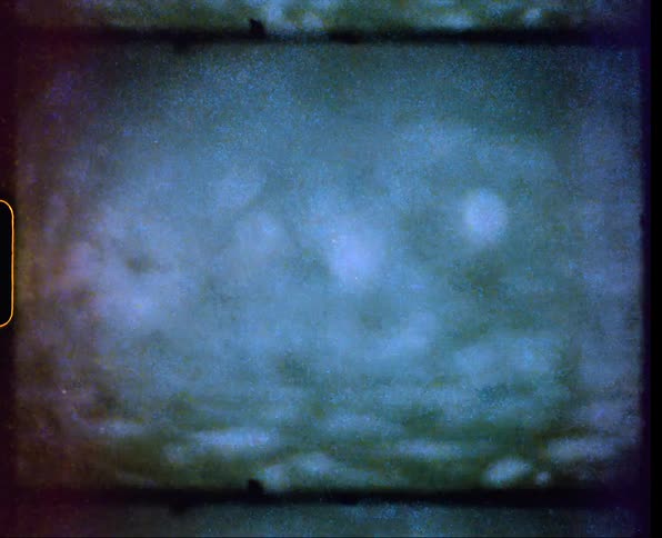 Close up of rainfall over a pond caught on vintage film